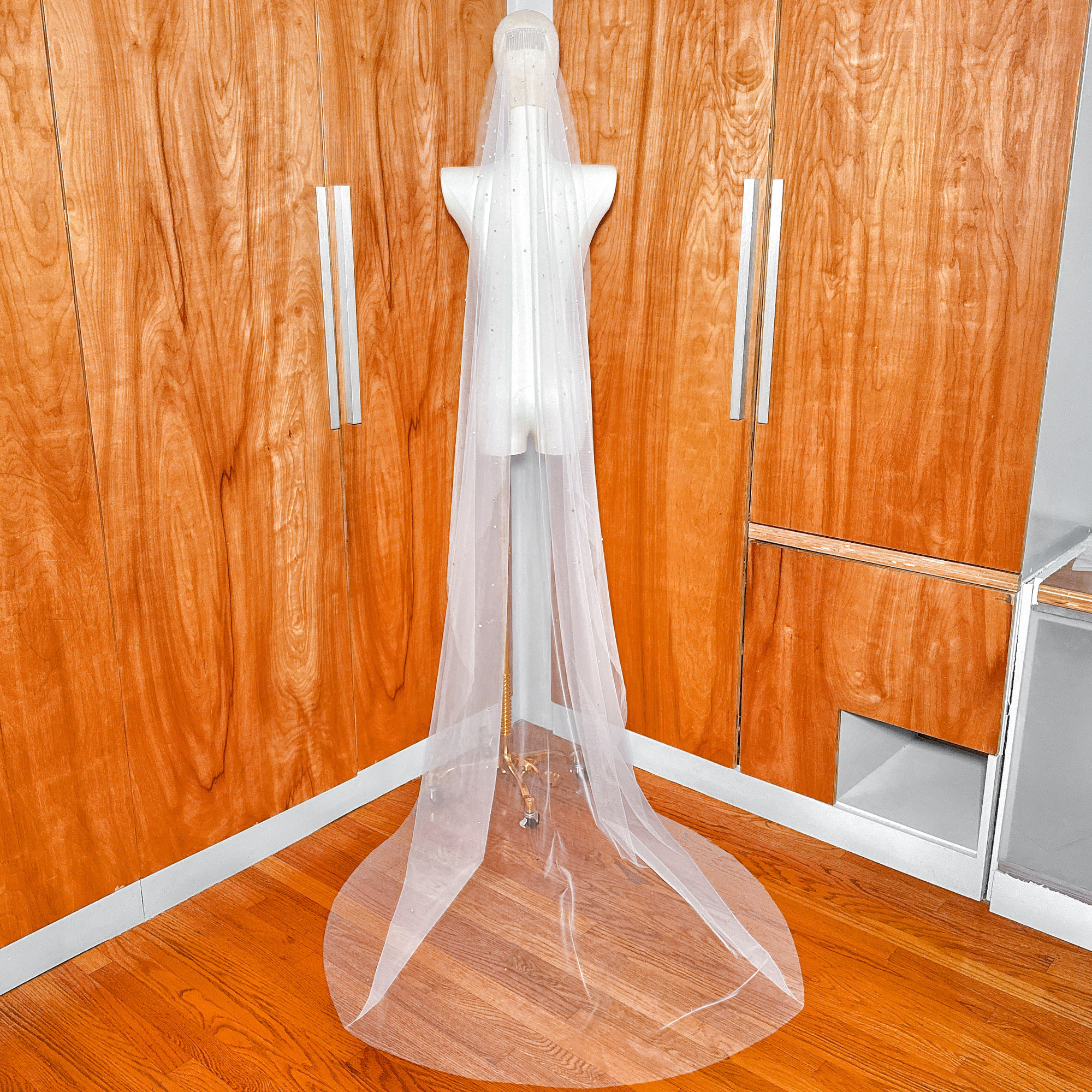Back view of a cathedral length scattered rhinestone mantilla wedding veil.