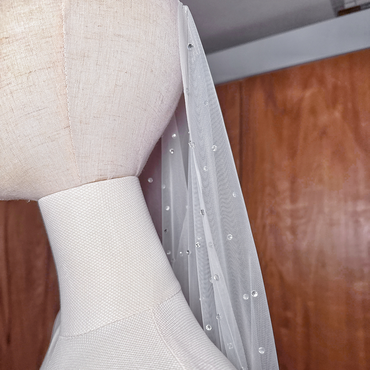 Details on a scattered rhinestone mantilla wedding veil.