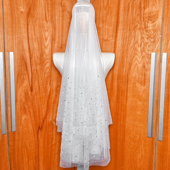 Secure metal comb attachment sewn onto the scattered rhinestone two tier wedding veil.