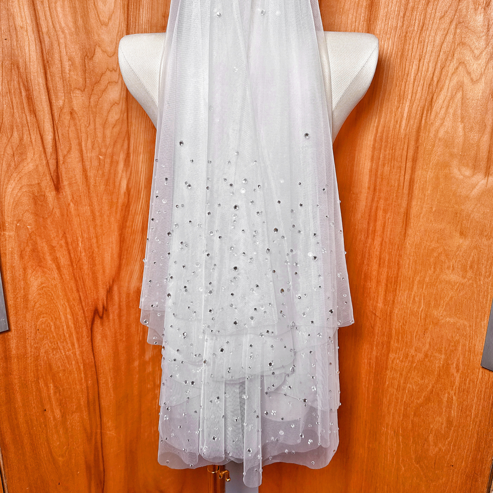 Clean cut edge finish on the sheer scattered rhinestone two tier wedding veil.