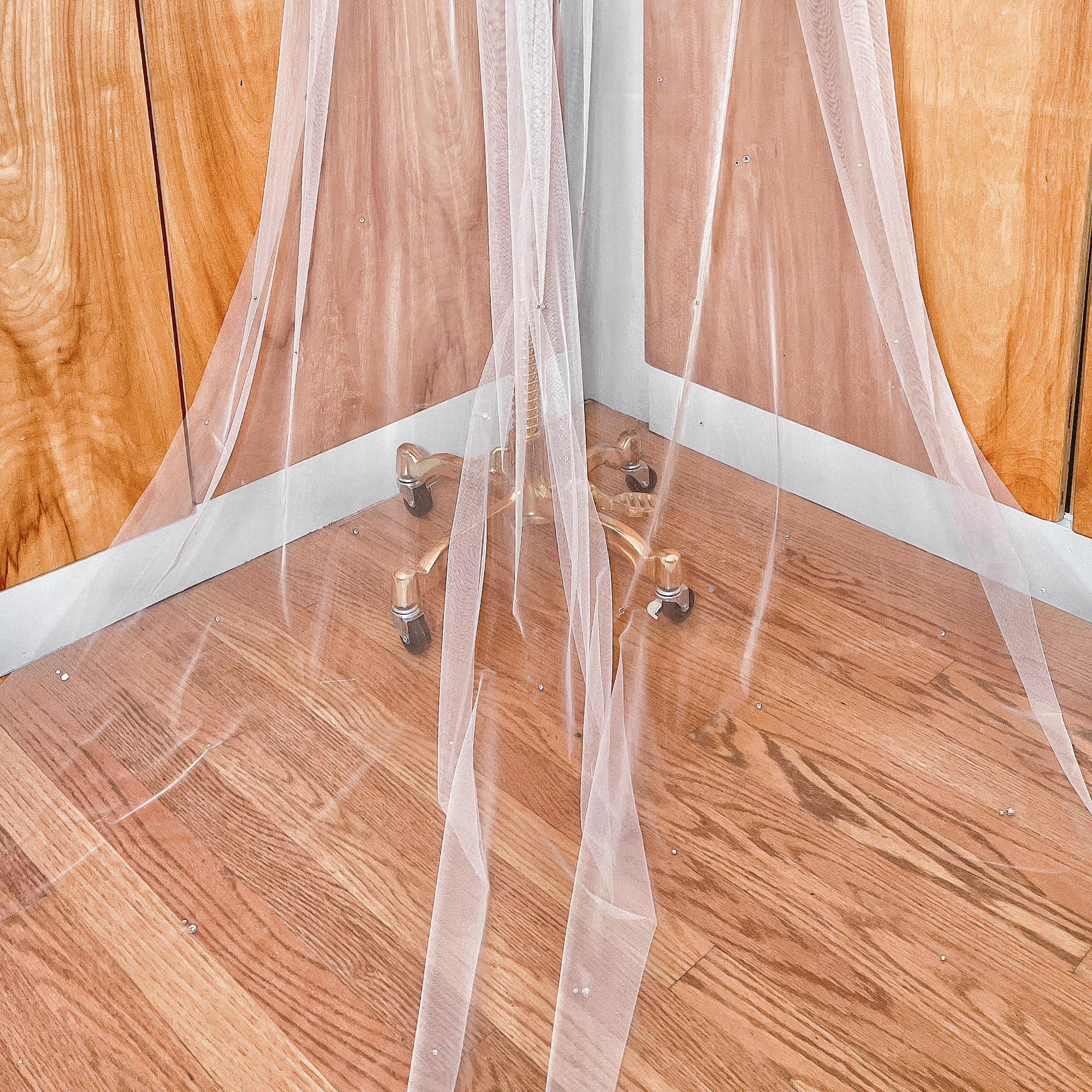 Sheer bridal tulle fabric featuring a delicate scattered rhinestone wedding veil design.