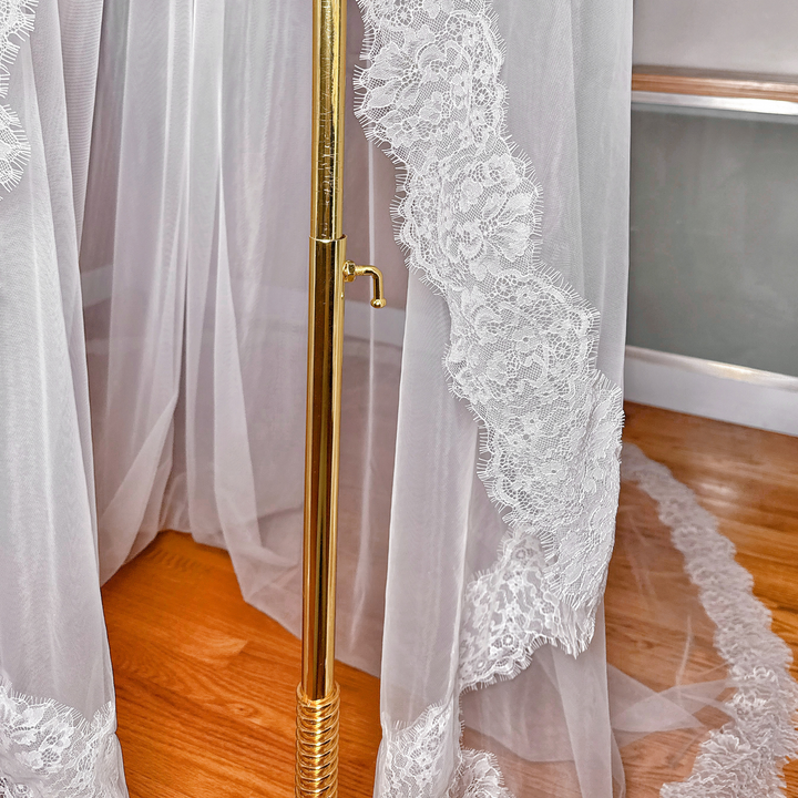 Close-up of the sheer cathedral length fabric and floral patterns of a Chantilly lace mantilla veil.