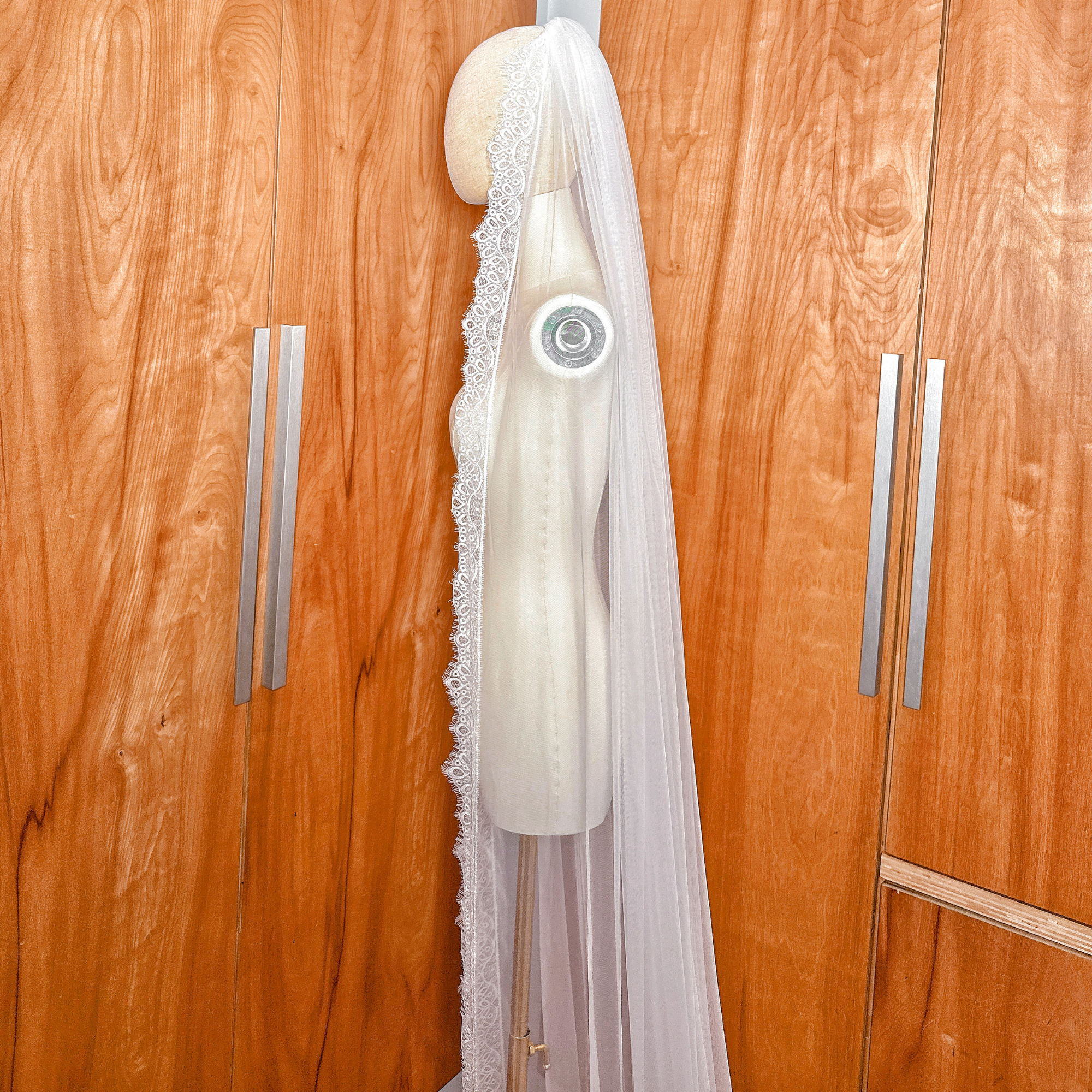 Sheer cathedral length bridal veil with delicate Chantilly lace trim.