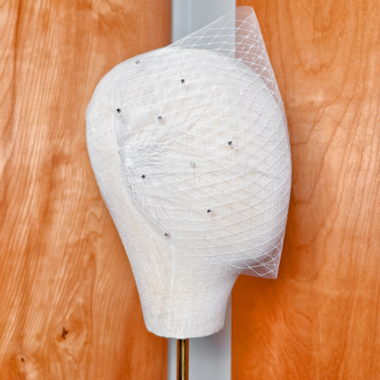 Sheer bridal tulle of a double layer bandeau wedding veil with shimmering rhinestones.