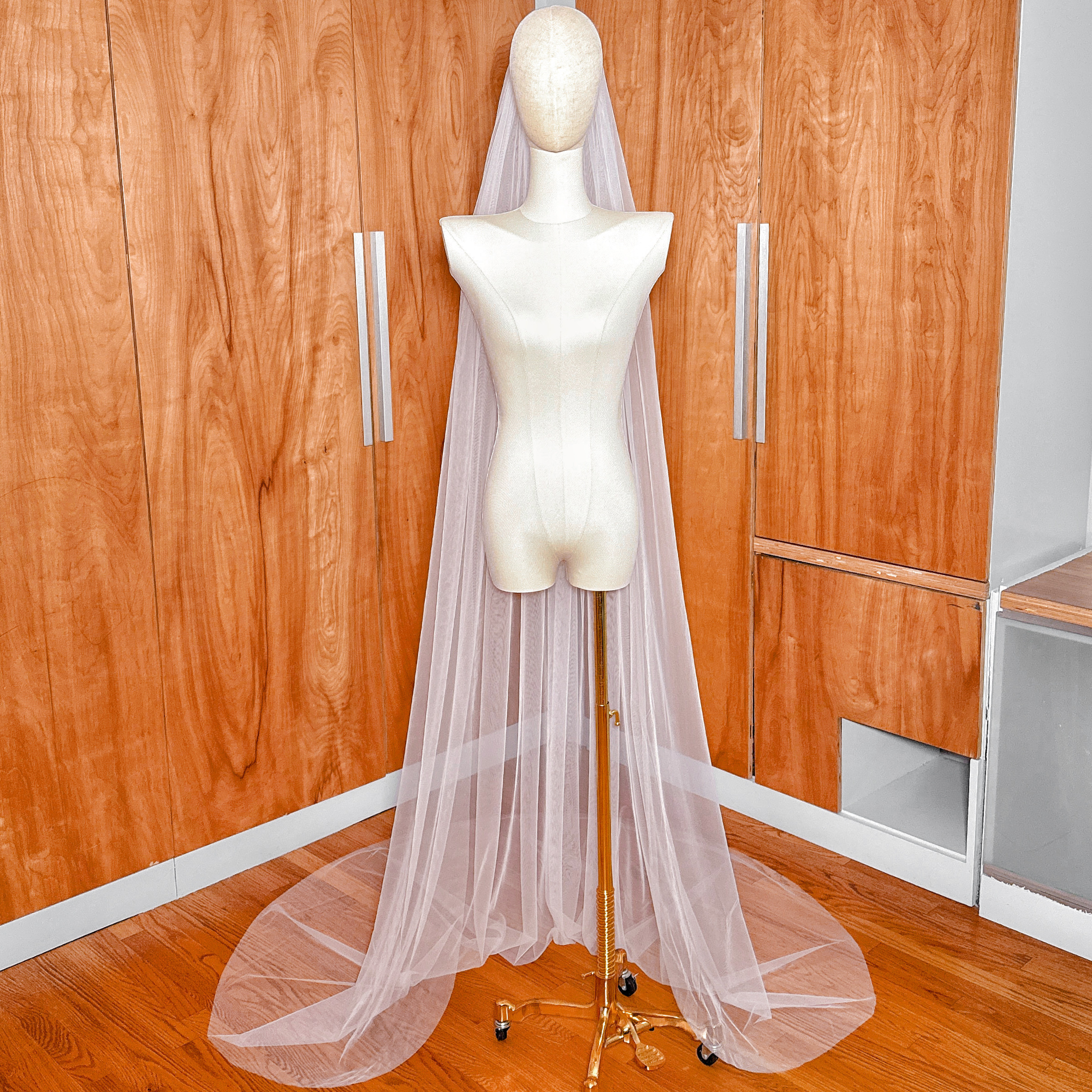 Detail of the lightweight, sheer tulle fabric used in this simple chapel length raw edge veil.