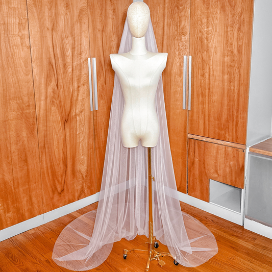 Detail of the lightweight, sheer tulle fabric used in this simple chapel length raw edge veil.