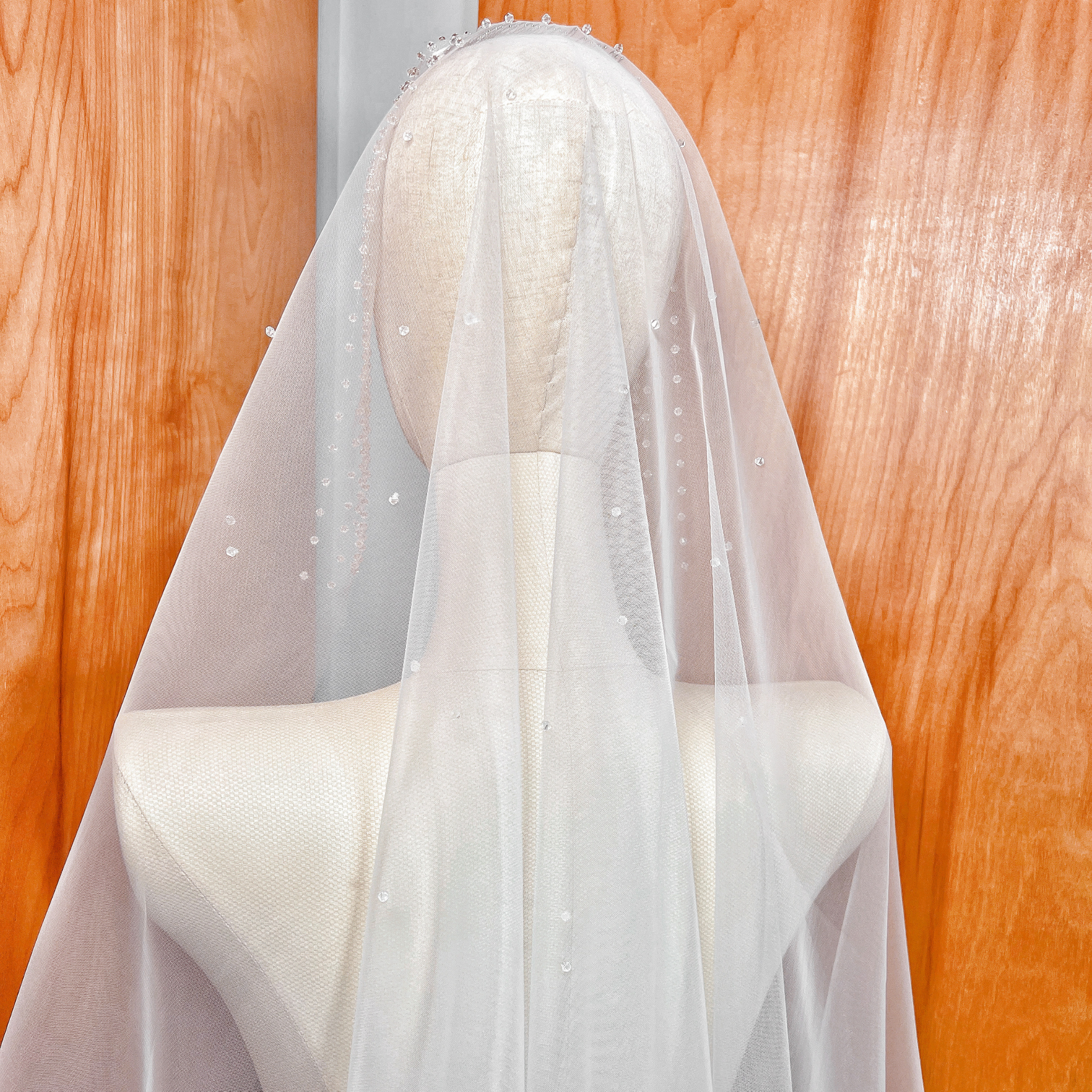 High-resolution view of the sheer bridal tulle and crystal edging of the fingertip-length Crystal Edge Mantilla Wedding Veil.