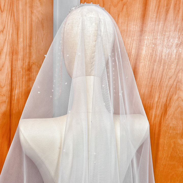 High-resolution view of the sheer bridal tulle and crystal edging of the fingertip-length Crystal Edge Mantilla Wedding Veil.