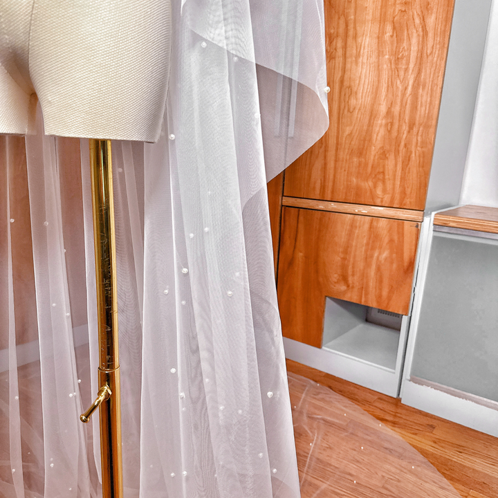 Lightweight two tier scattered pearl wedding veil in cathedral length with a simple blusher.