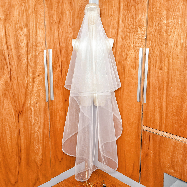 Waltz length two tier wedding veil with 1/2" horsehair trim and blusher overlay shown on a mannequin.