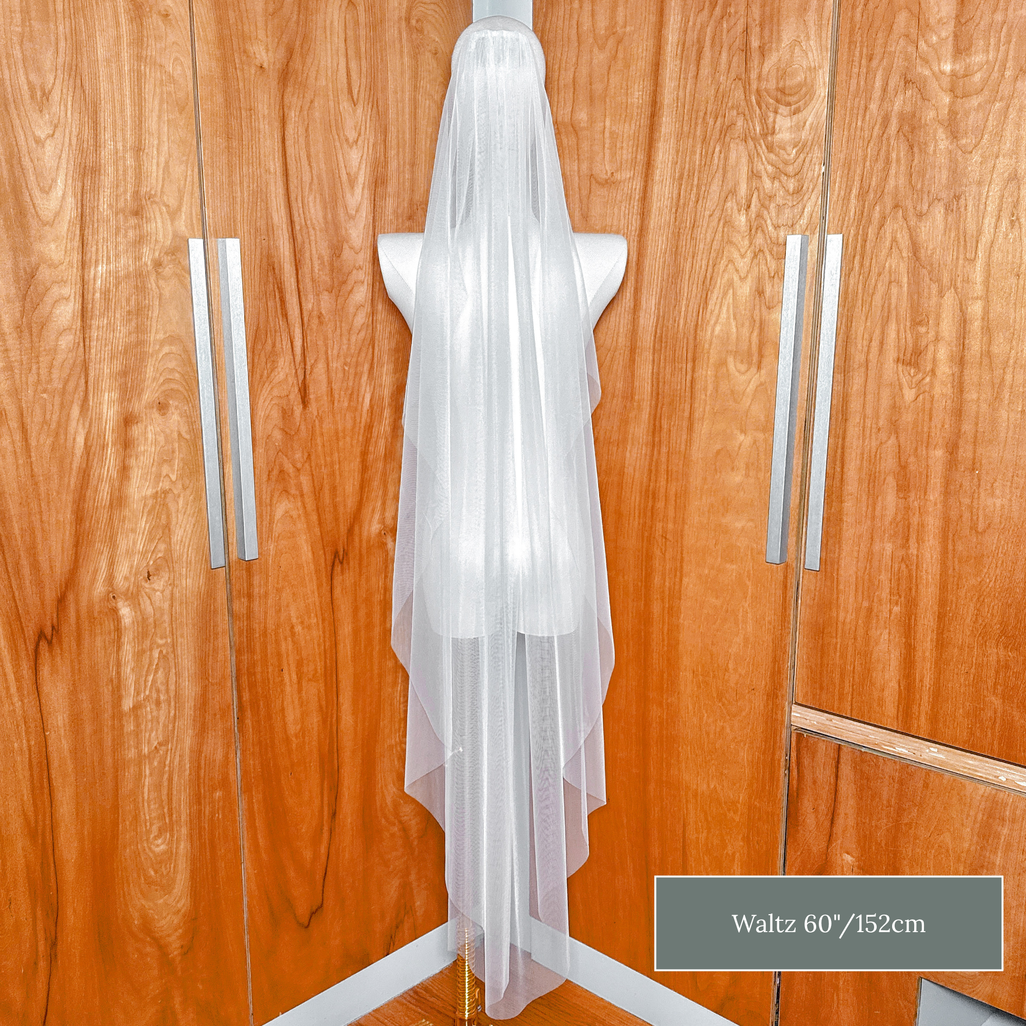 Lightweight raw edge cascade wedding veil in waltz length for an effortless bridal look.