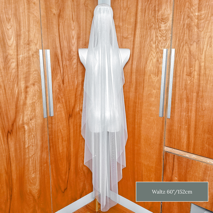 Lightweight raw edge cascade wedding veil in waltz length for an effortless bridal look.