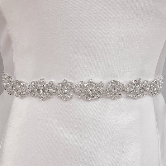 Close-up detail of the intricate crystal rhinestone beadwork on the silver beaded bridal belt.