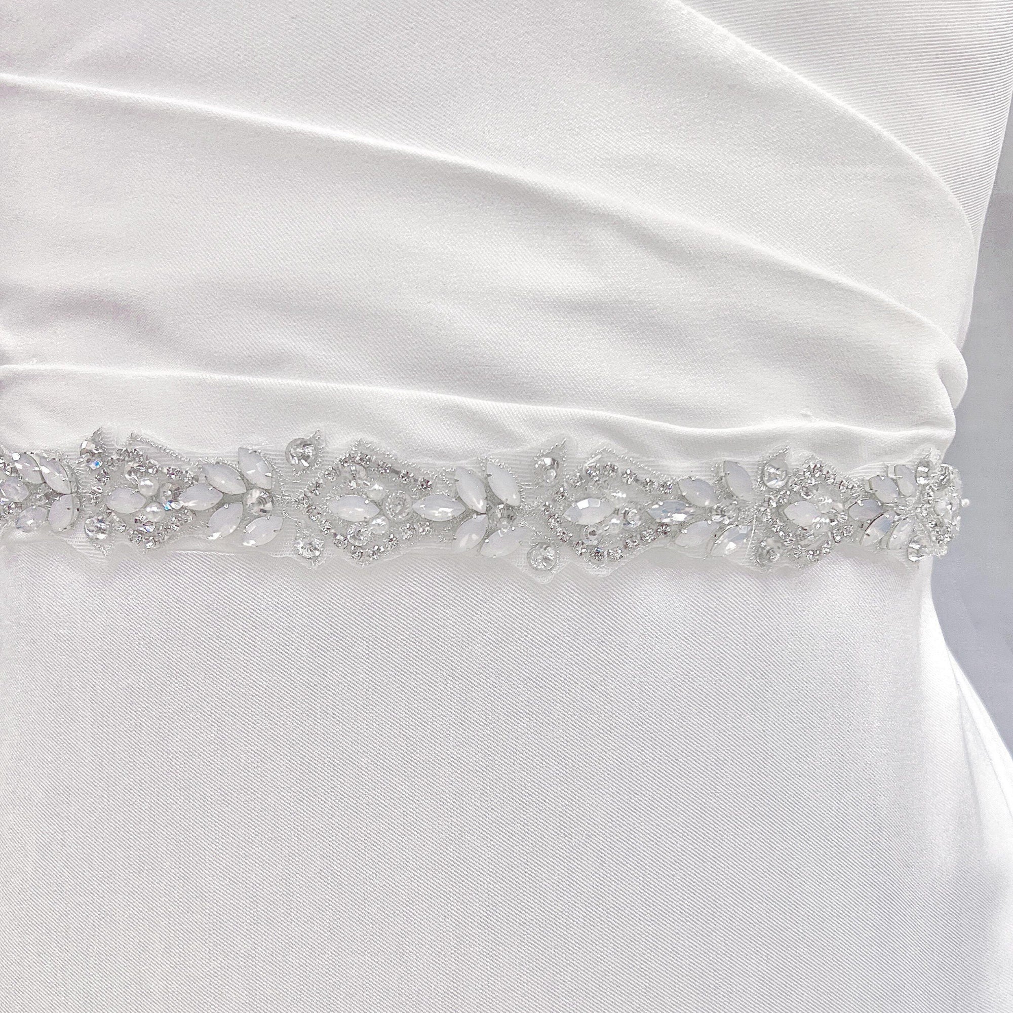 Close-up view of the silver rhinestone and pearl bridal belt showcasing the detailed floral crystal patterns.