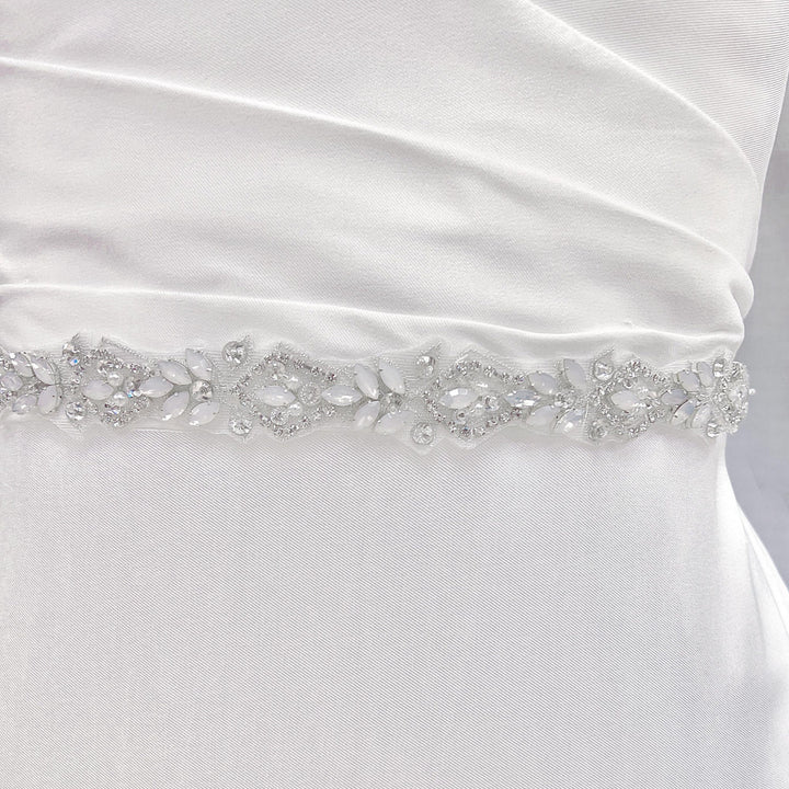 Close-up view of the silver rhinestone and pearl bridal belt showcasing the detailed floral crystal patterns.