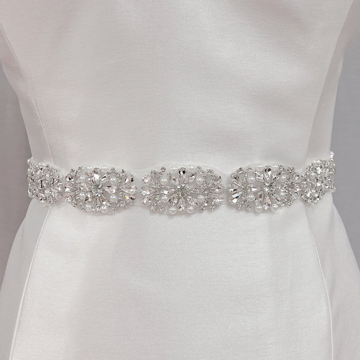 Full-length view of a silver rhinestone and pearl bridal belt.