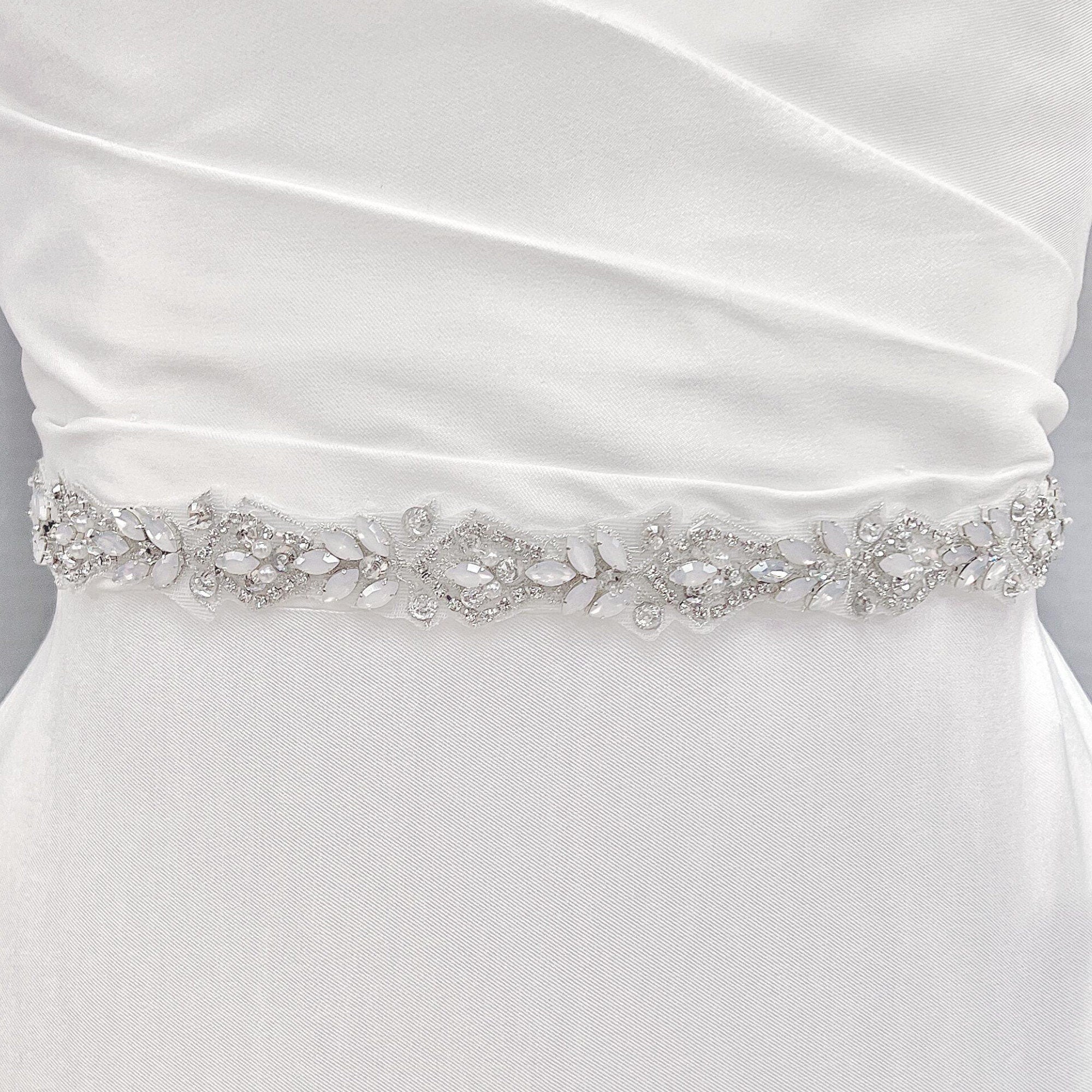 Silver rhinestone and pearl bridal belt with intricate crystal beadwork displayed on a bridal mannequin.