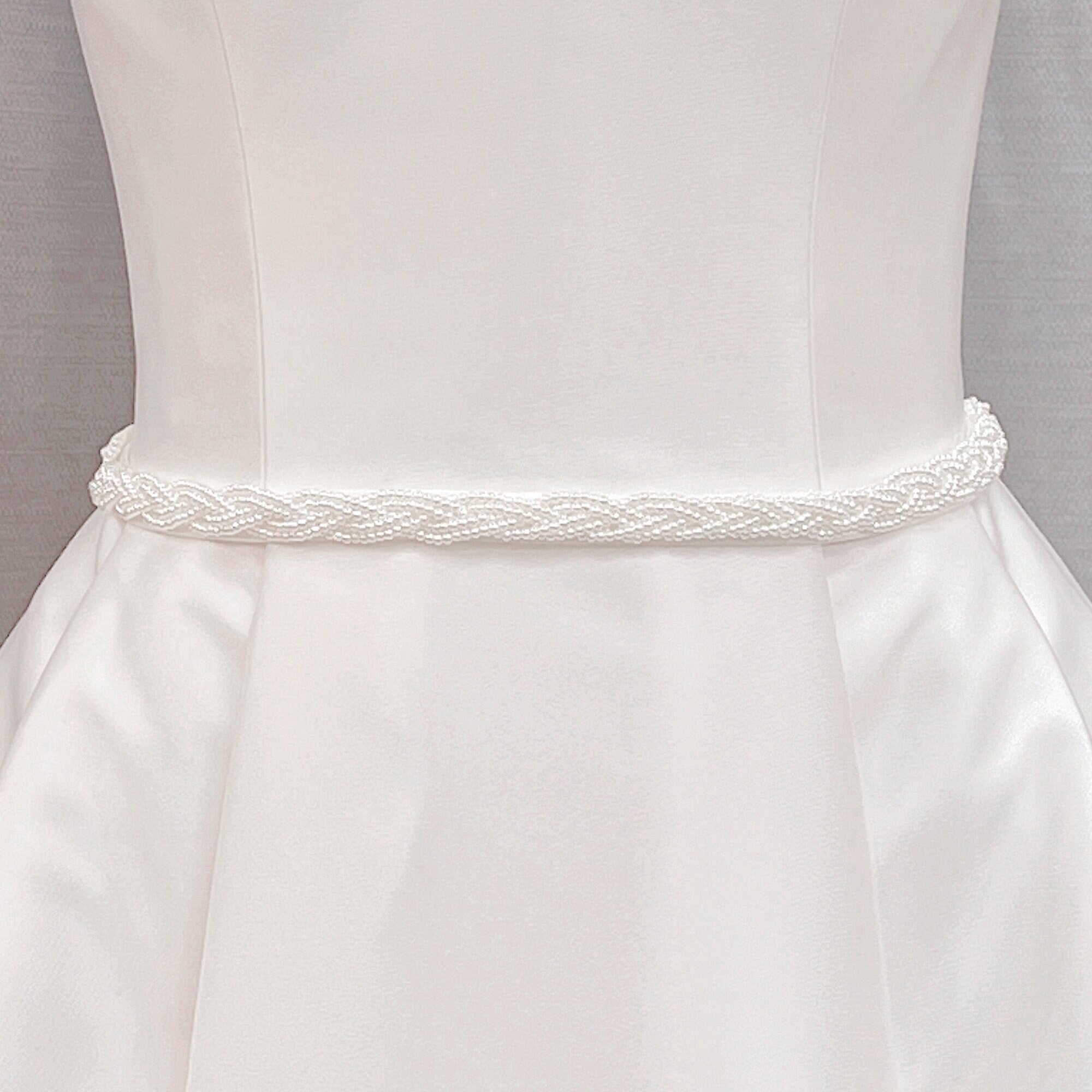 Simple Pearl Bridal Belt with a minimalist white wedding sash displayed on a bridal mannequin.