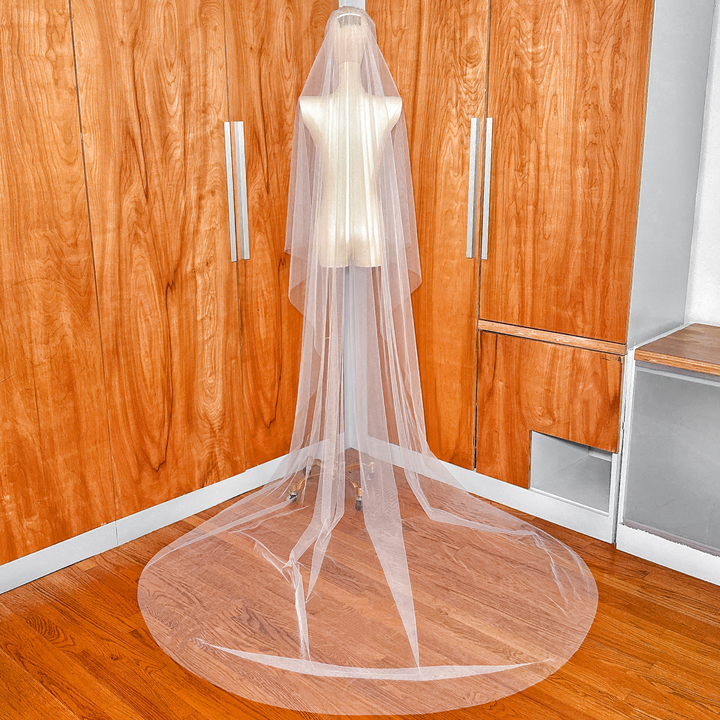 View of the sturdy metal comb attachment on a simple soft two-tier cathedral length veil.