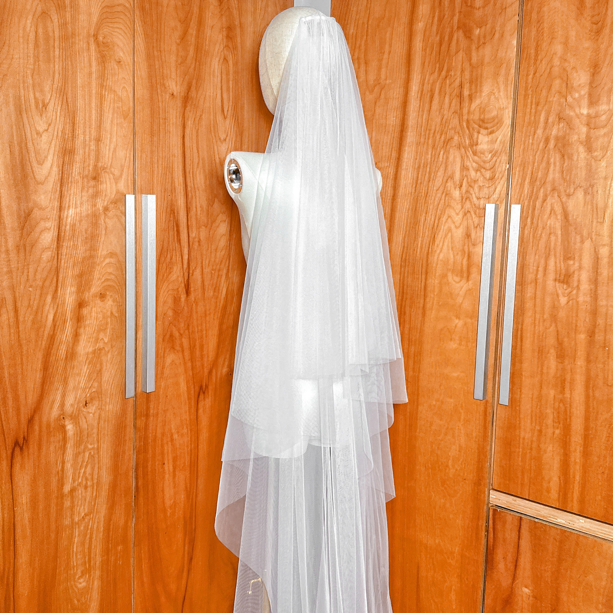 Close-up detail of the layering on a simple soft two-tier cathedral length bridal veil.