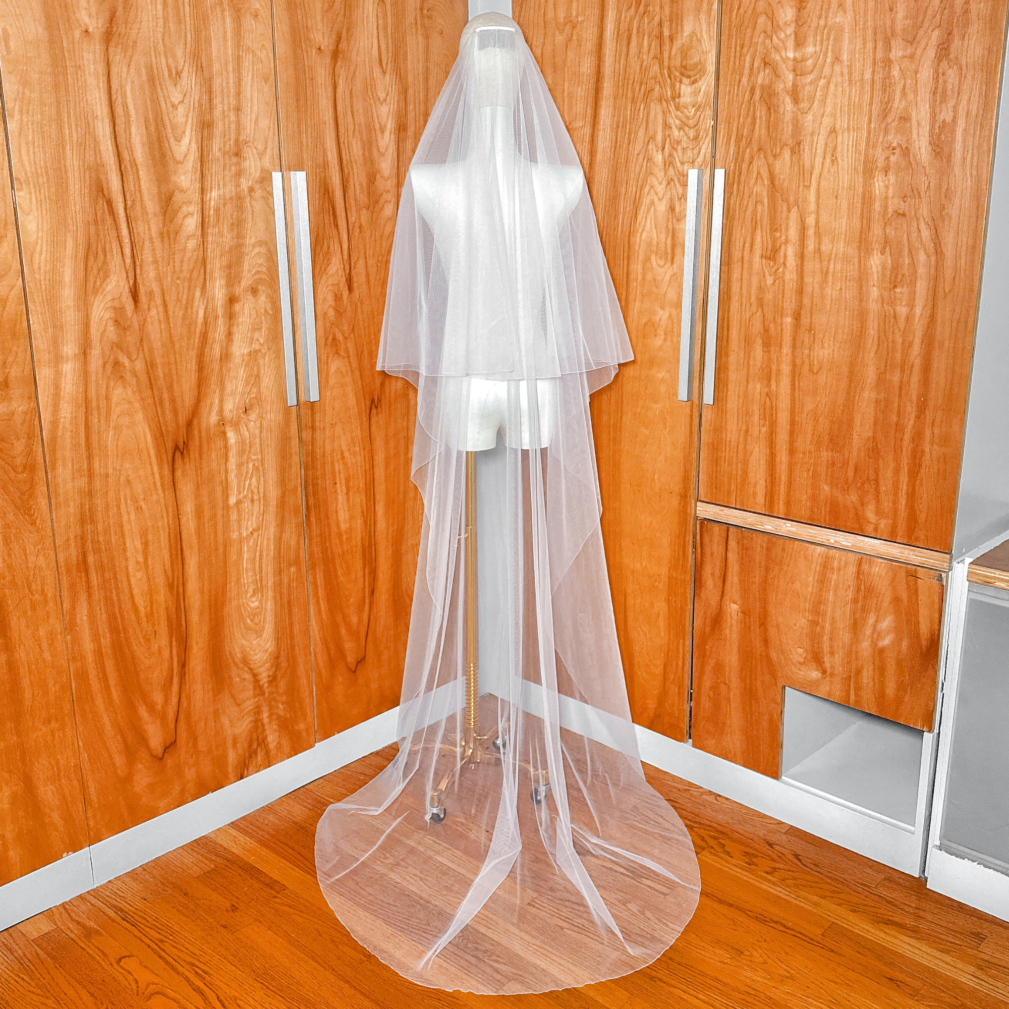 Secure metal comb attachment sewn onto a simple two tier bridal veil with pencil edge.