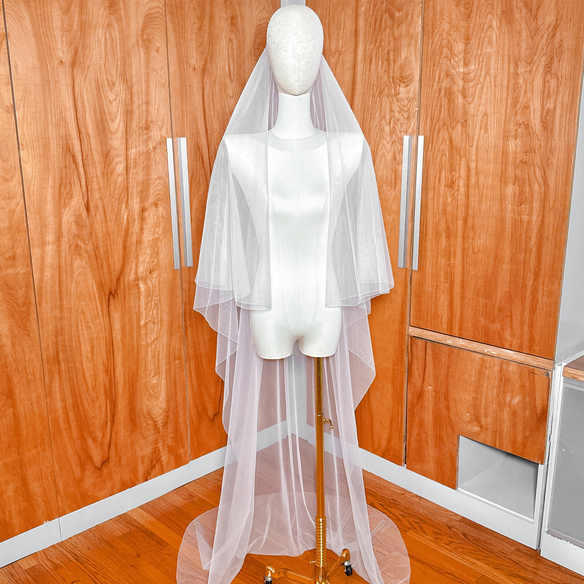 High-quality sheer bridal tulle fabric of a simple two tier bridal veil with pencil edge.