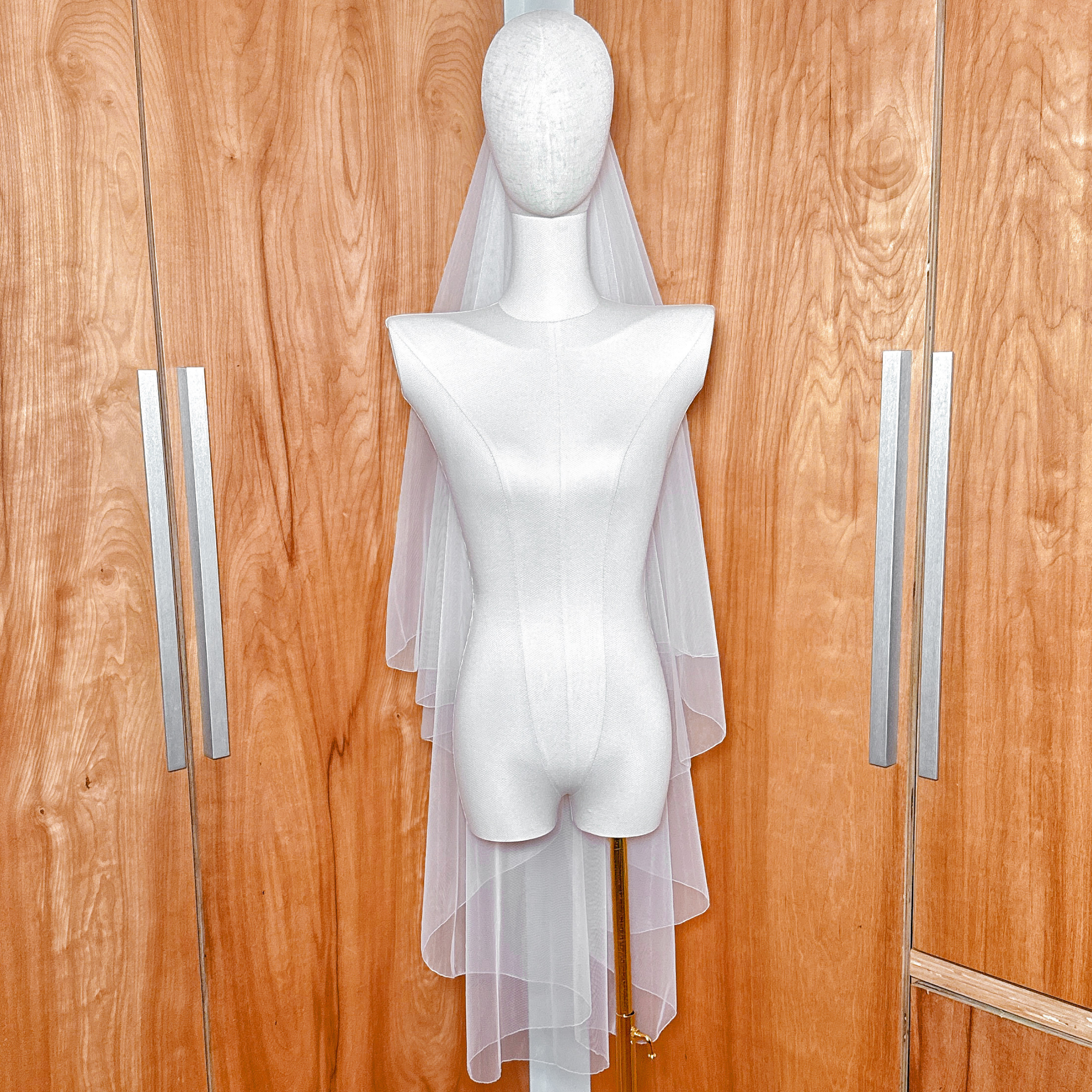 Simple two tier wedding veil with a clean pencil edge finish shown from the back.