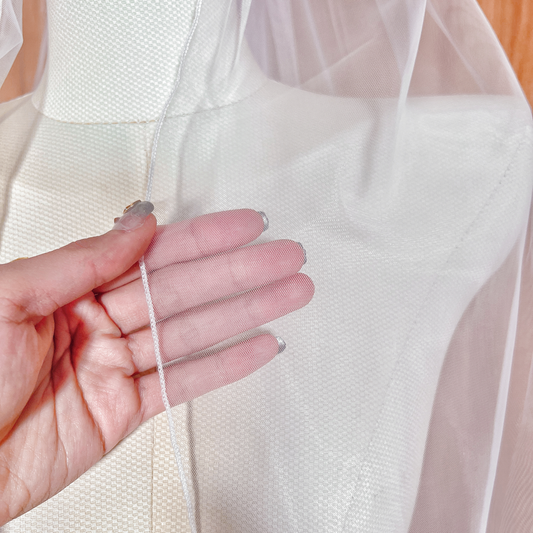 Close-up of the delicate piping on a single tier pencil edge wedding veil.