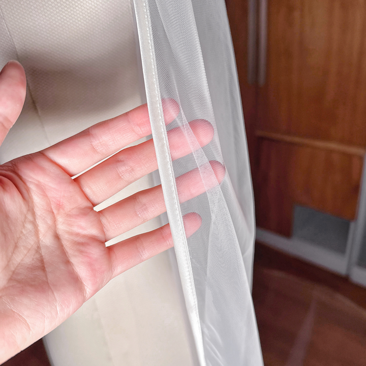 Close-up of the satin border on a single tier ribbon edge wedding veil.