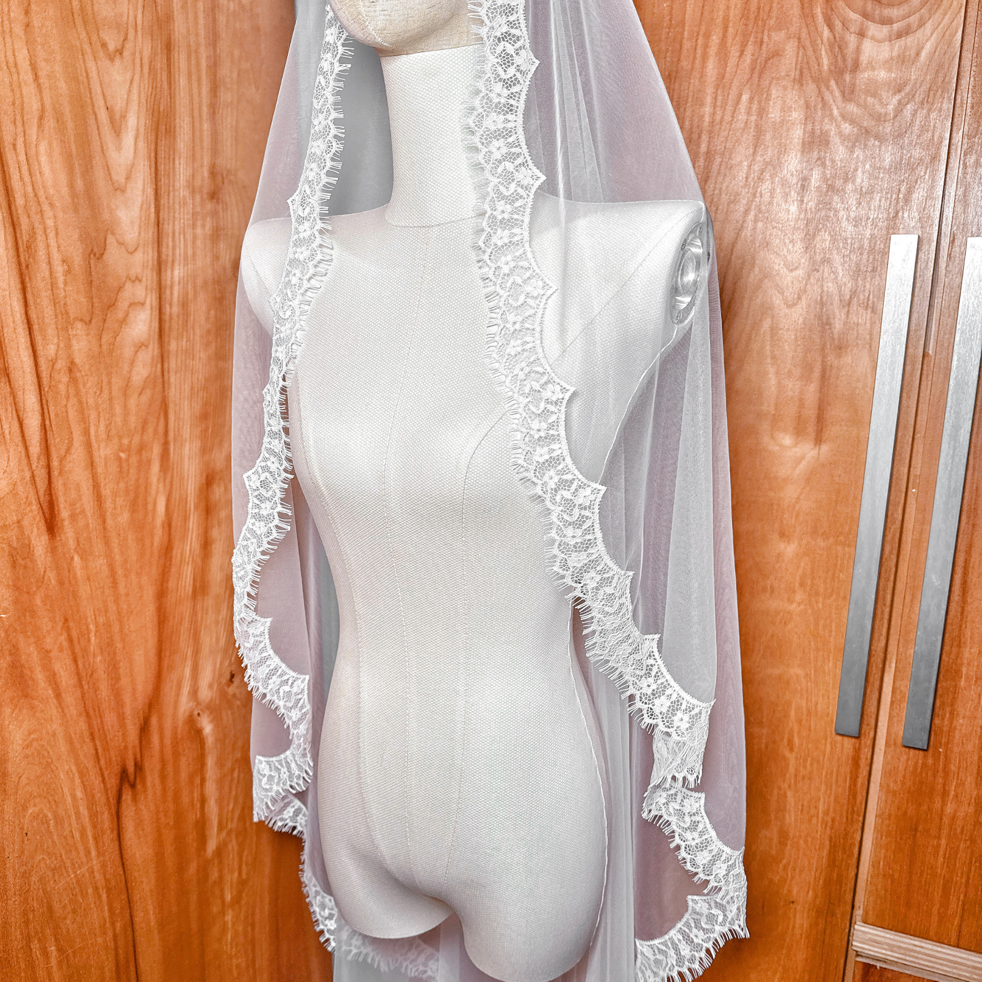 Lightweight soft tulle mantilla wedding veil with scalloped eyelash lace in waltz length.