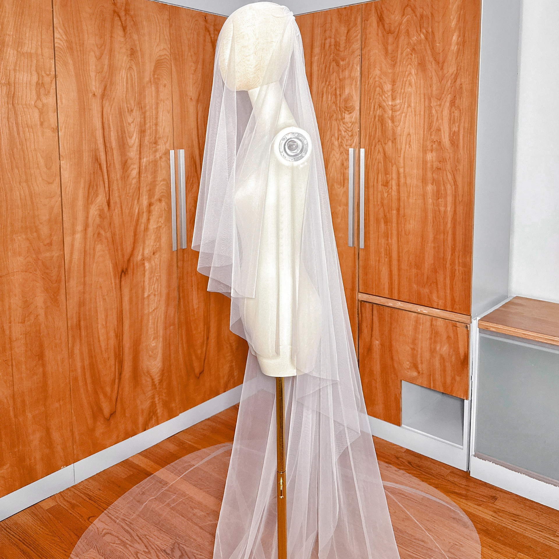 Close shot of the soft tulle fabric on a simple two-tier cathedral length wedding veil.