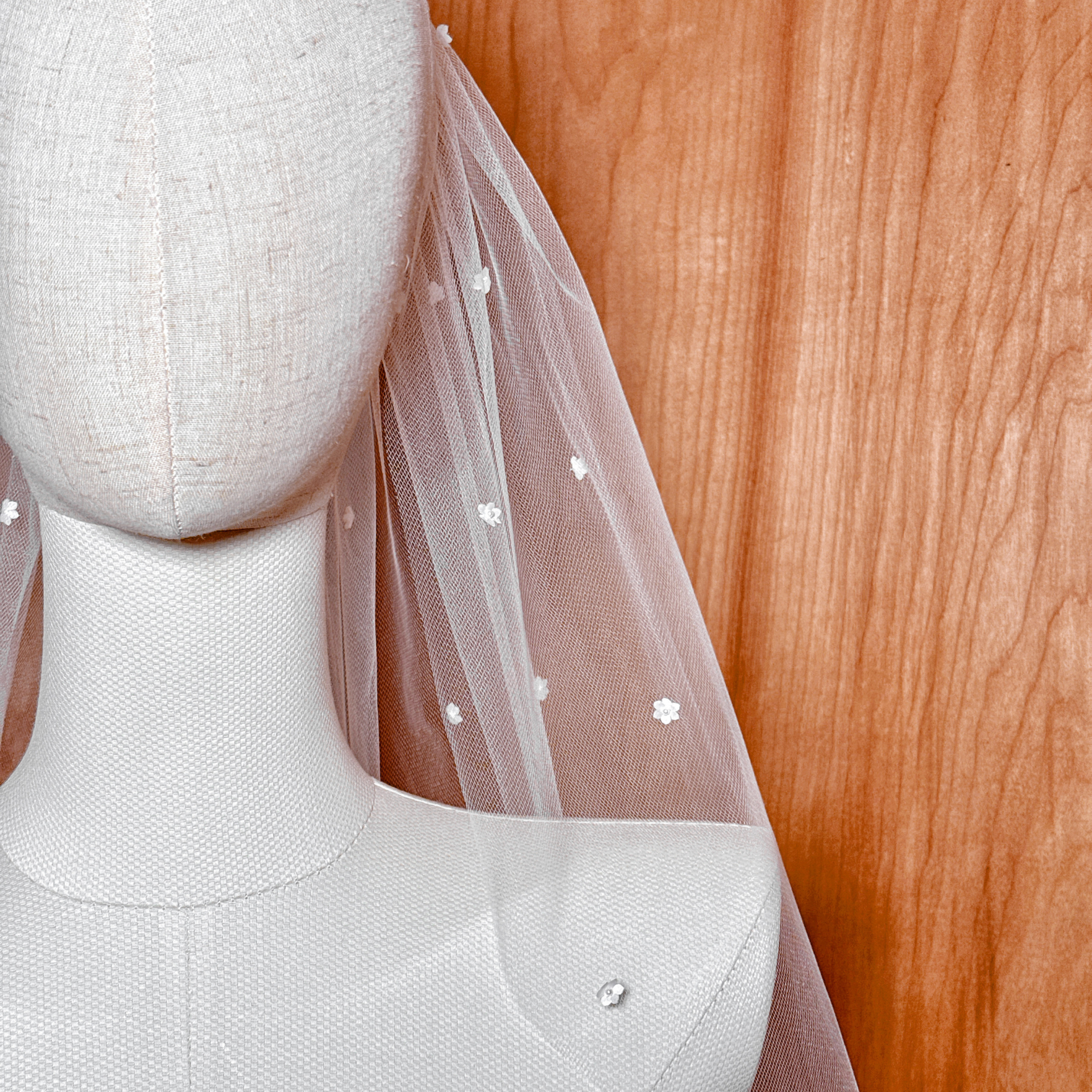 A macro shot detailing a single silk flower with its Swarovski pearl center to highlight product craftsmanship.