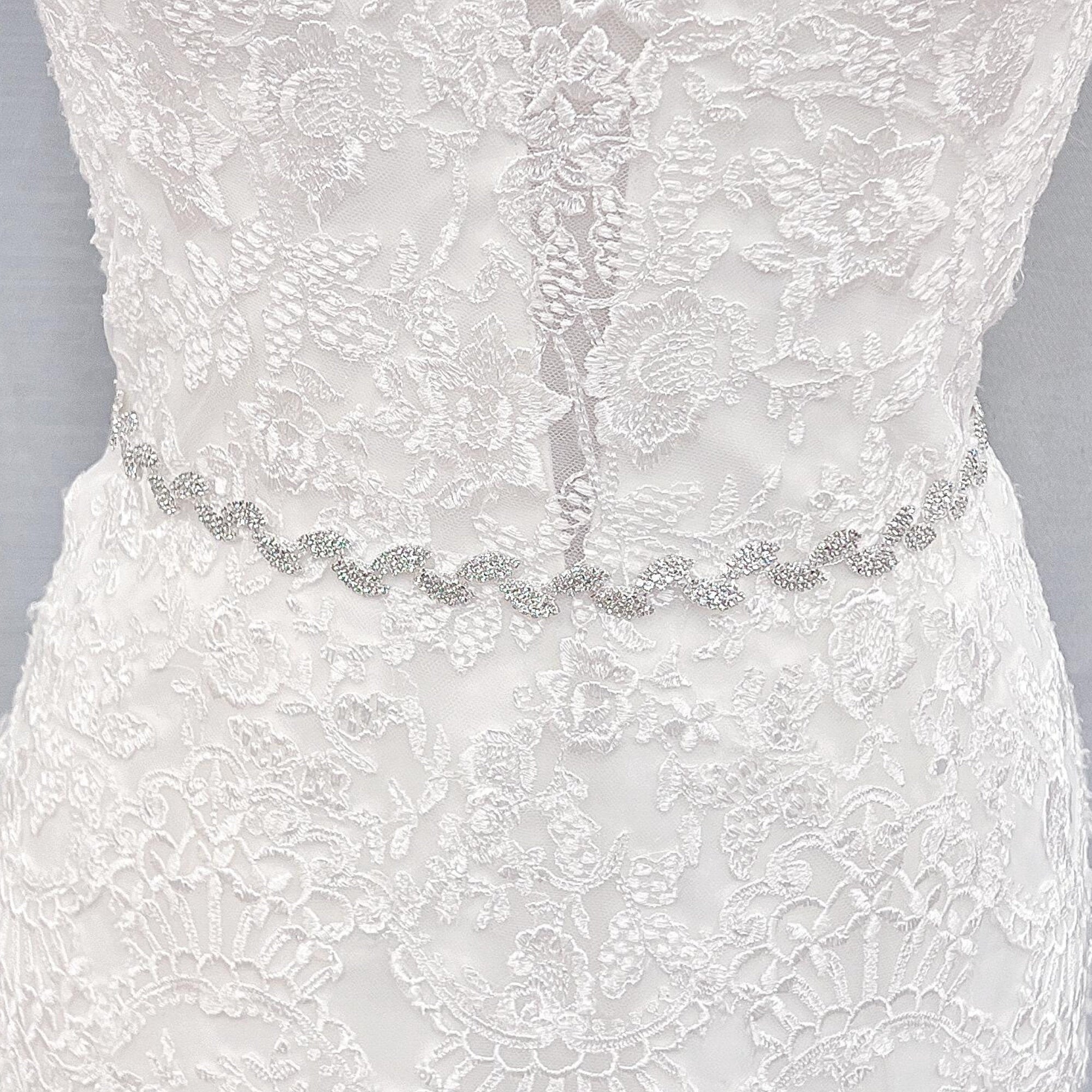 Full-length view of a thin silver crystal bridal belt showcasing the elegant rhinestone pattern.