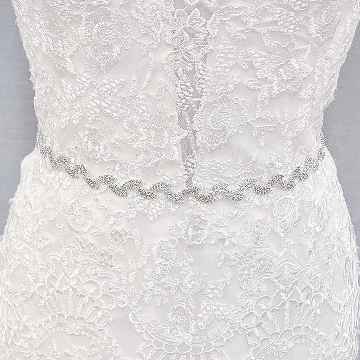 Full-length view of a thin silver crystal bridal belt showcasing the elegant rhinestone pattern.