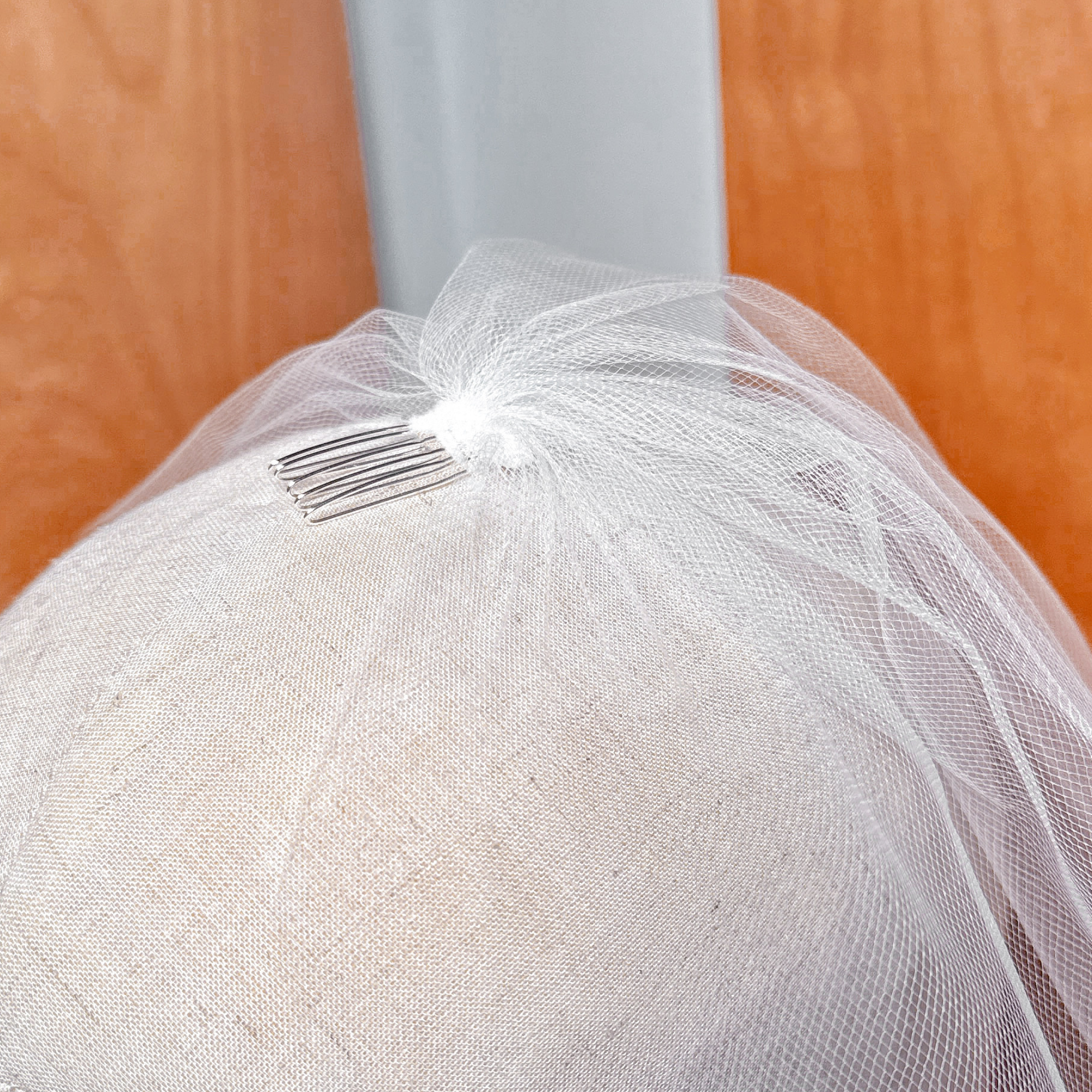 Extreme close-up of the delicate netting pattern on a tulle birdcage wedding veil.