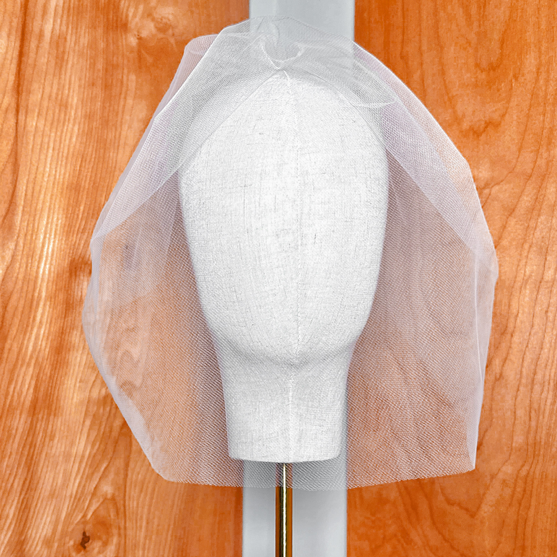Front view of the Tulle Birdcage Wedding Veil in Vintage Style for a Civil Ceremony, displayed on a bridal mannequin to show how the sheer netting drapes over the face.