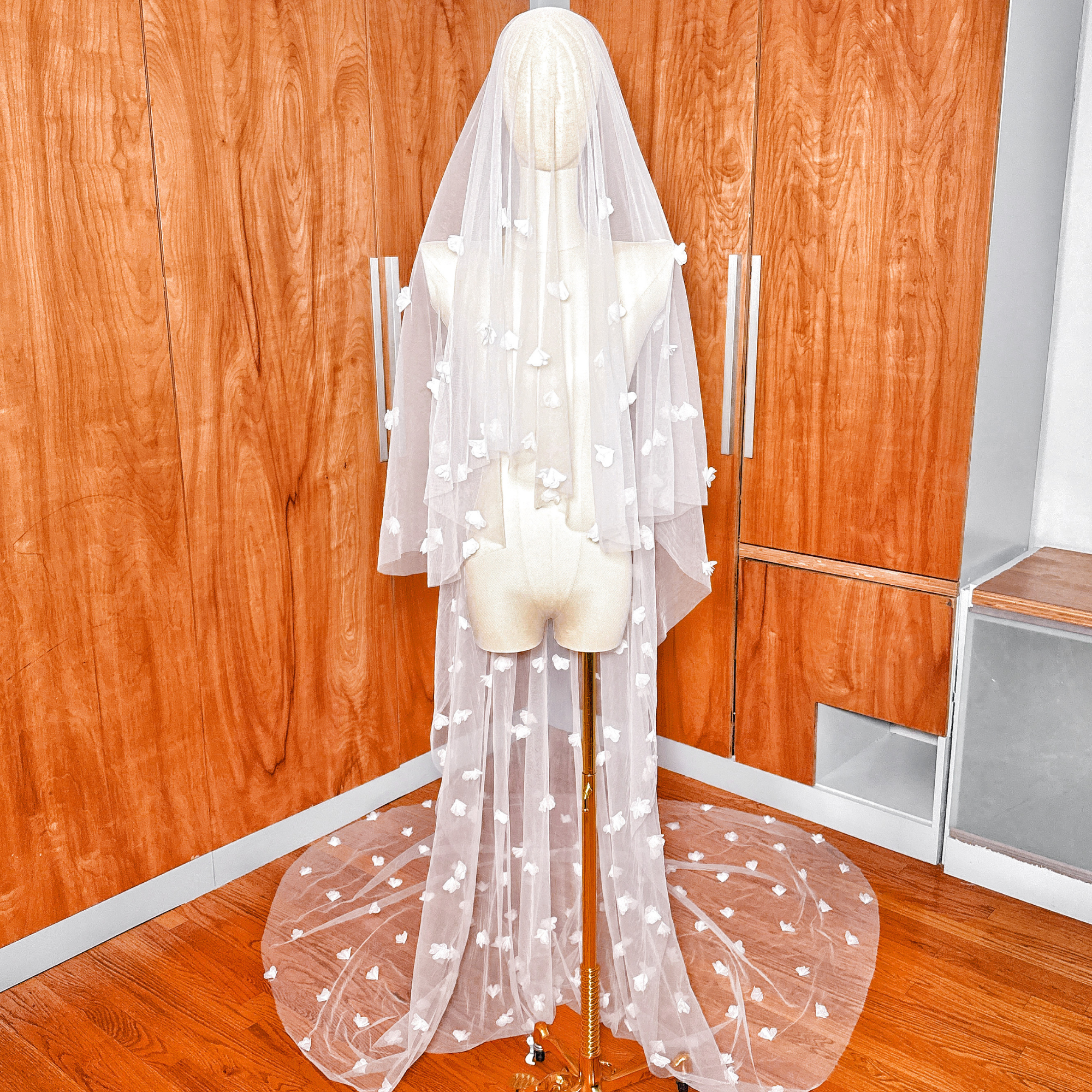 Cathedral length two tier 3D floral wedding veil with blusher displayed on a mannequin.