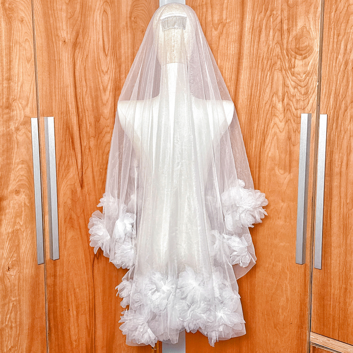 Back view of the comb attachment on a fingertip length two tier 3D flower wedding veil.