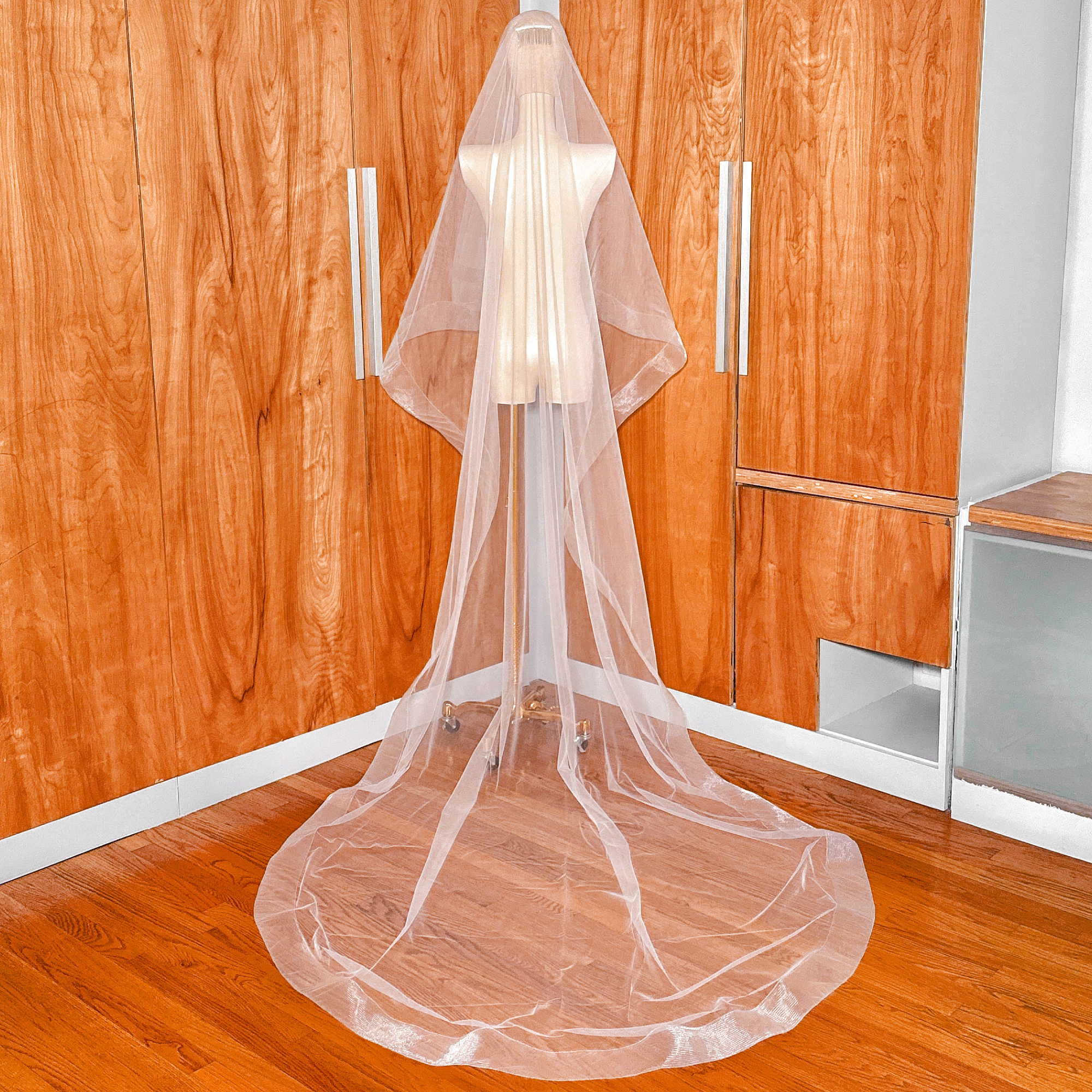 Back view of a 3 inch horsehair trim two tier wedding veil in cathedral length with a sheer blusher layer.