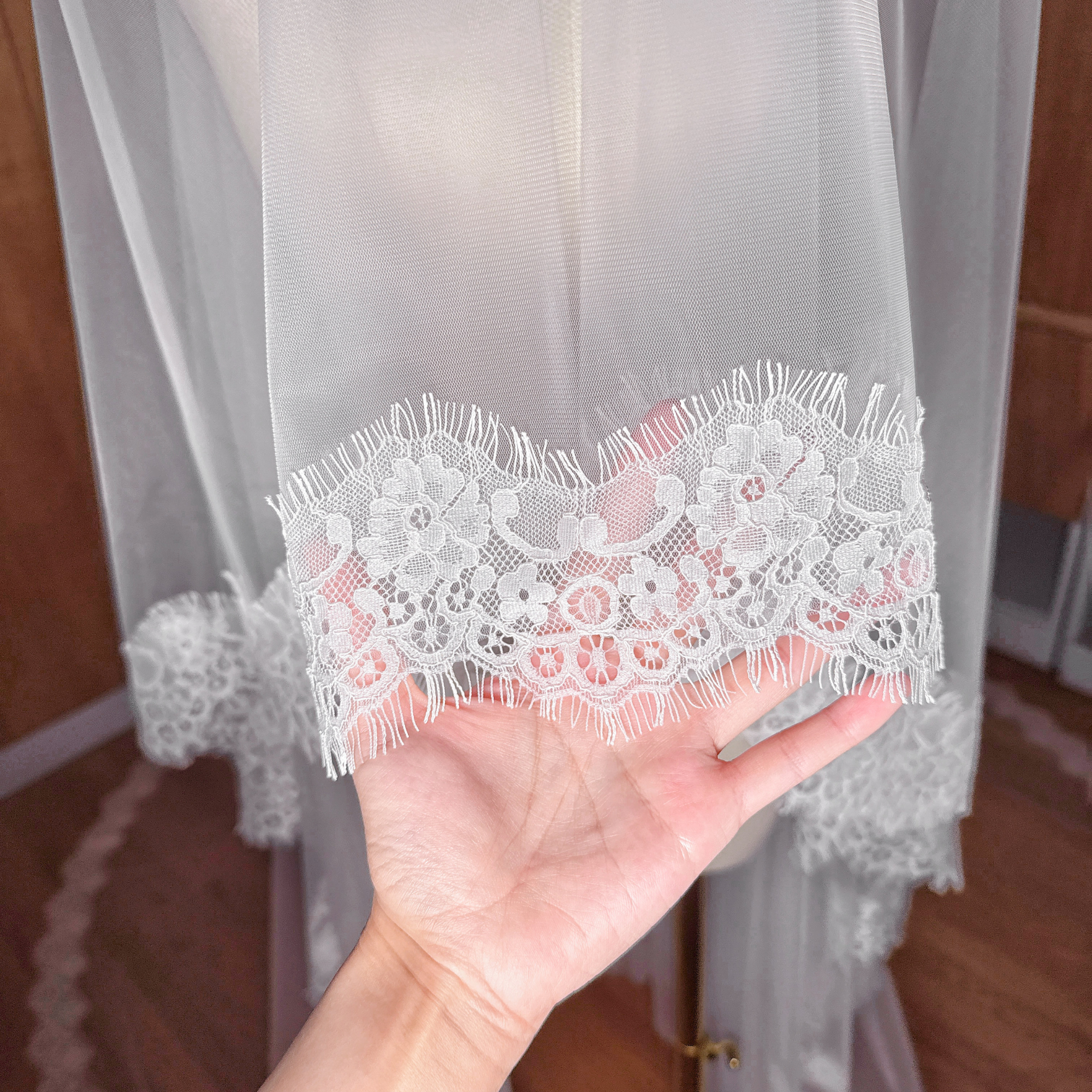 Close-up of the intricate floral Chantilly lace border on a cathedral length Two Tier Wedding Veil.