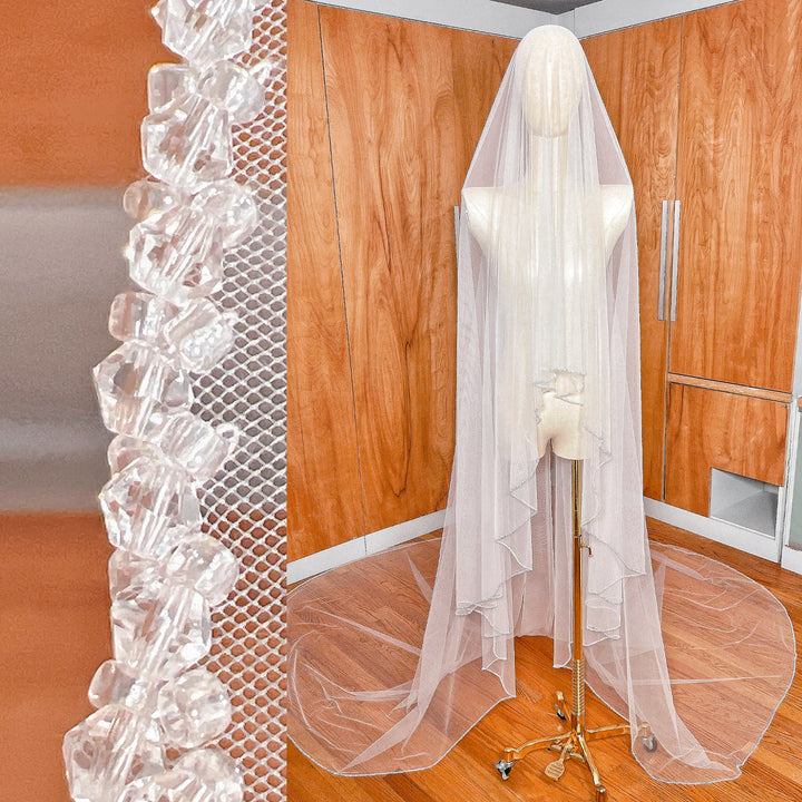 Front view showing the blusher tier forward on a two tier crystal beaded edge wedding veil.
