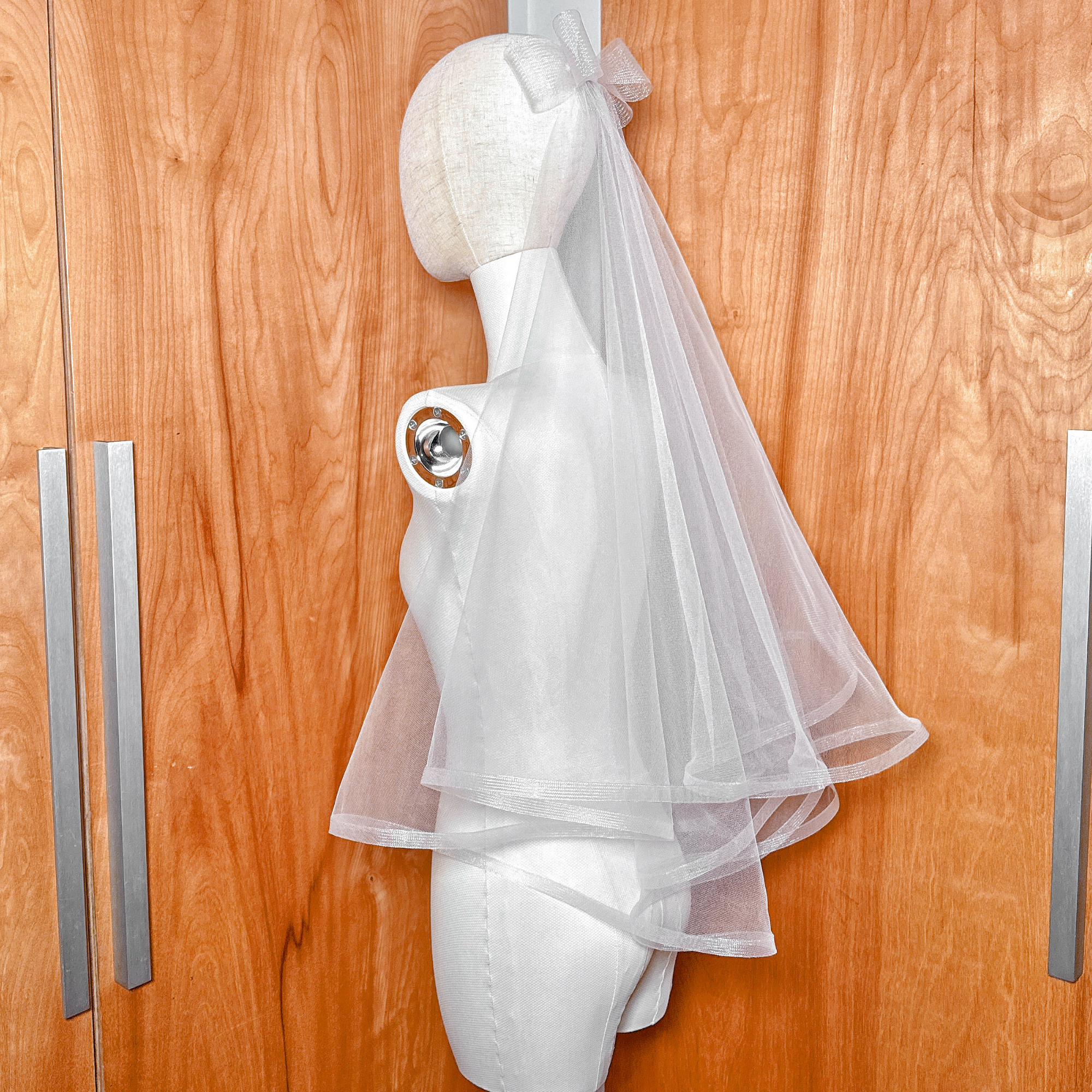 Side profile of a two tier horsehair wedding veil in elbow length showing the volume and horsehair edge.