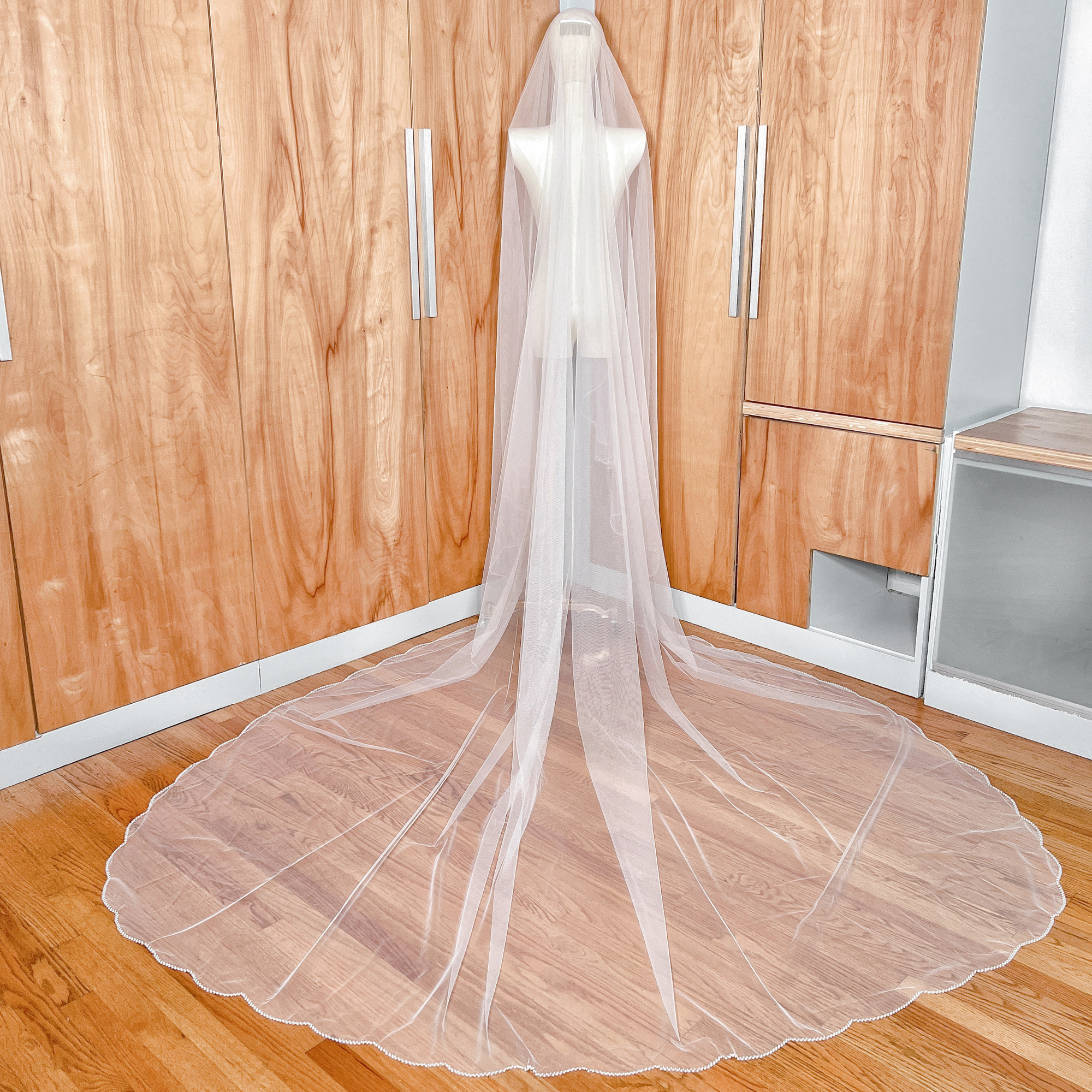 Back view of a two-tier pearl edge wedding veil with blusher in a formal cathedral length.