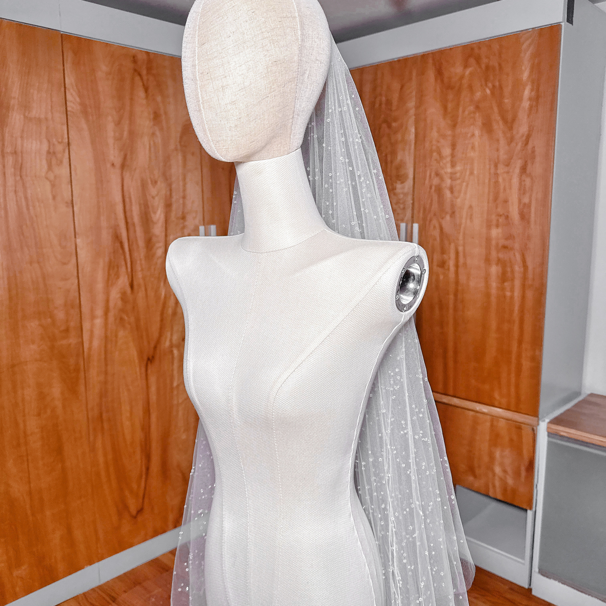 ide profile of a long two-tier scattered crystal beaded cathedral veil showing the graceful drop and volume.