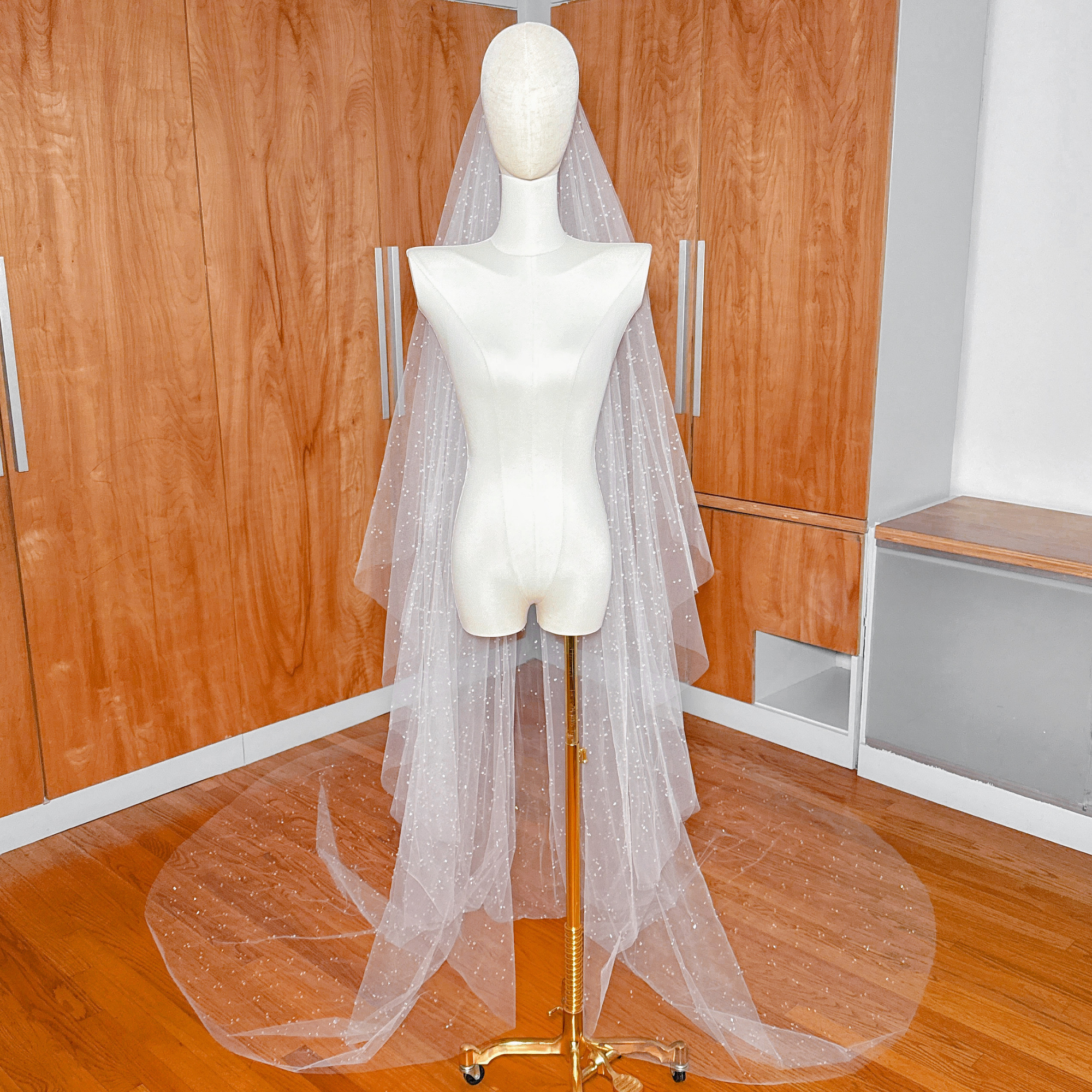 Luxury two-tier scattered crystal beaded cathedral veil featuring premium sparkle for formal wedding ceremonies.
