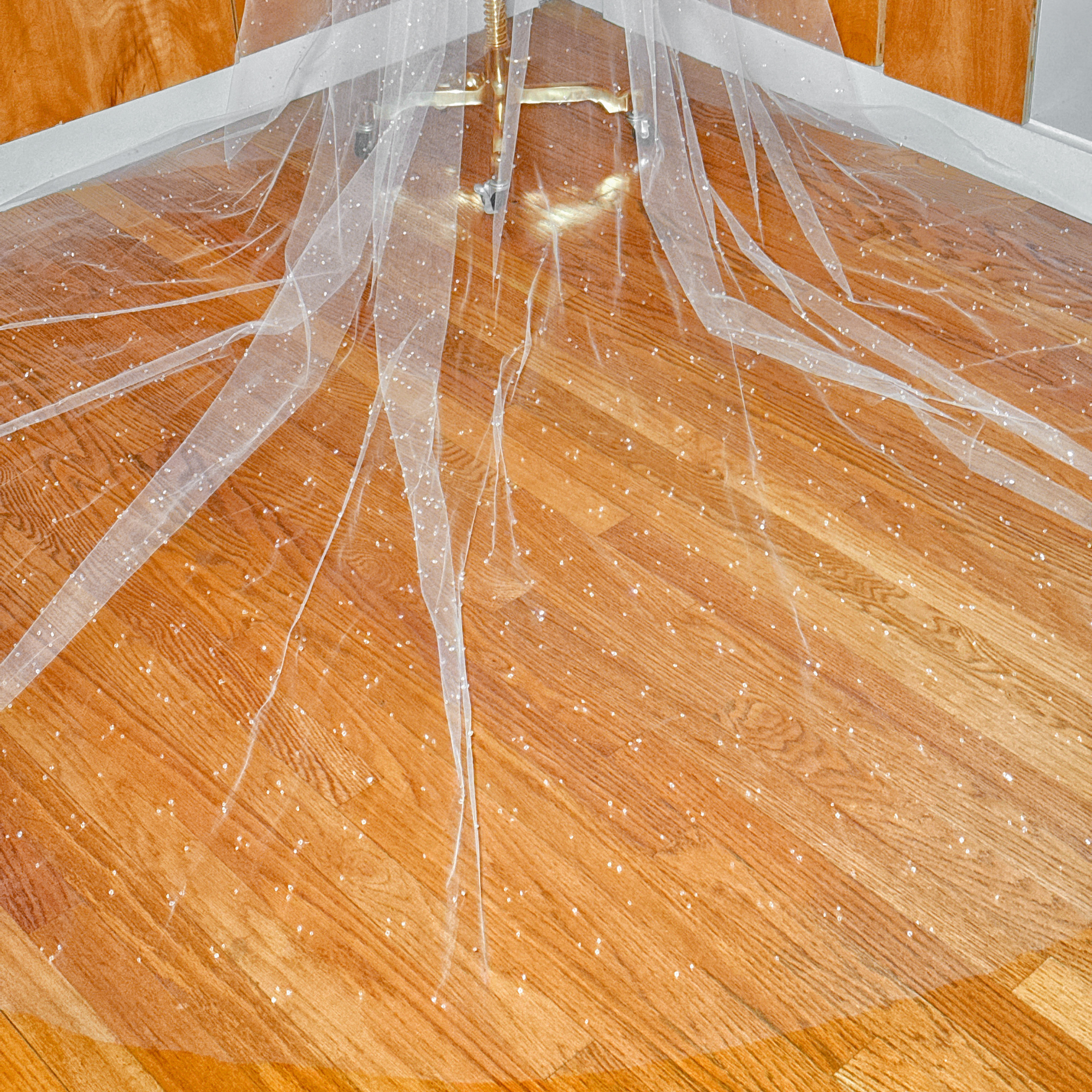 Detailed view of shimmering crystals on a two-tier scattered crystal beaded cathedral veil for a dramatic bridal look.