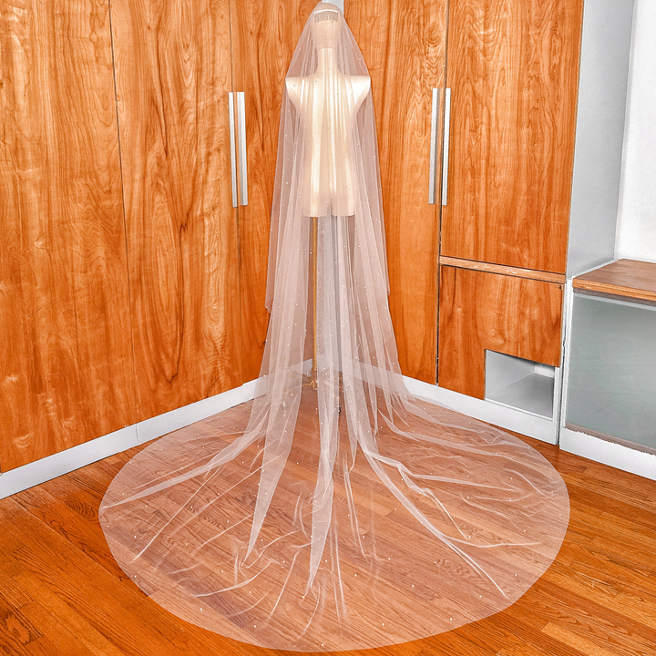 Cathedral length two tier scattered pearl wedding veil with blusher displayed in detail.