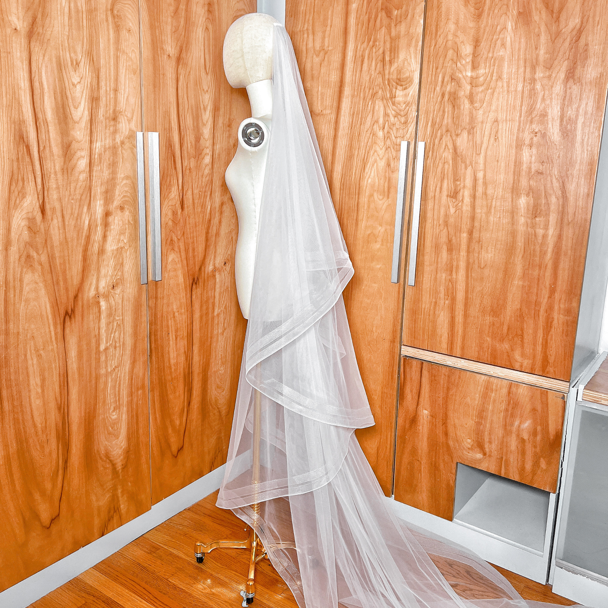 Detailed texture of the bridal tulle and double horsehair trim on a two tier cathedral length veil.