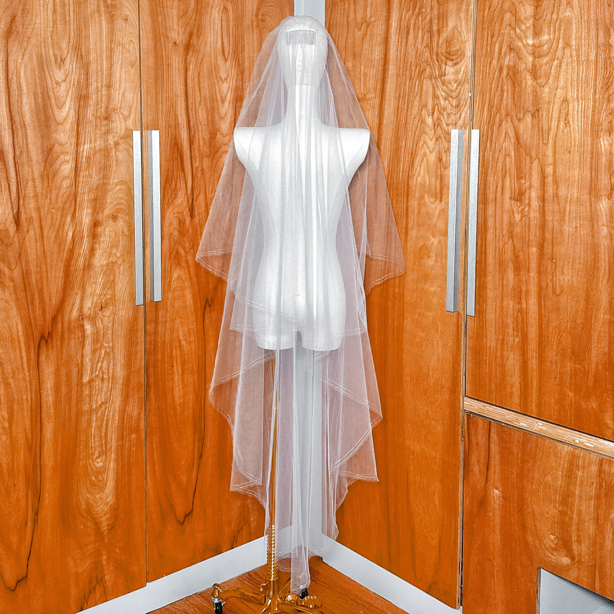 Elegant two tier bridal veil with gold metallic edge and blusher, waltz length style shown on a mannequin.