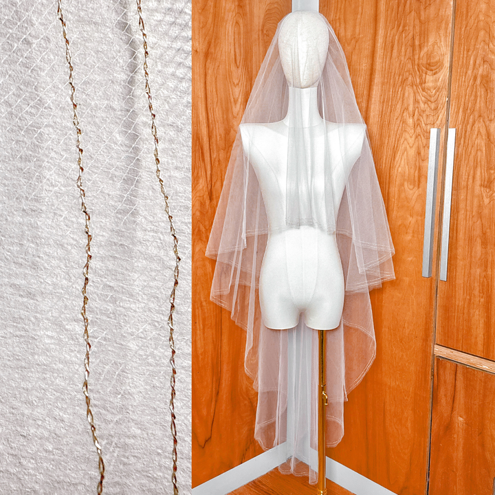 Two tier wedding veil with a gold metallic edge and blusher shown in waltz length on a mannequin.